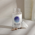 InfiniWell DNA PRIME dietary supplement bottle with capsules, white lid removed, 60 capsules.