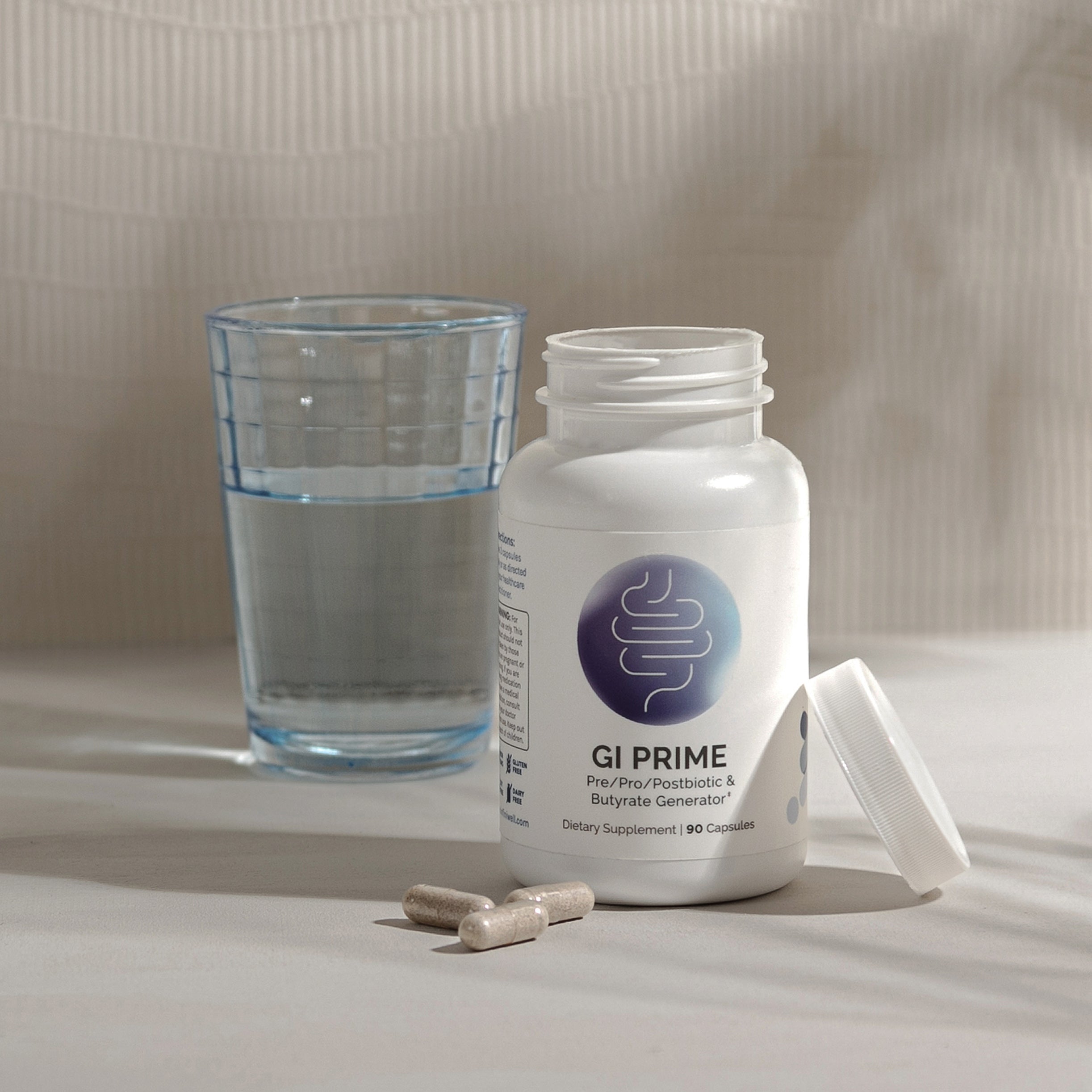 Supplement bottle, capsules, and glass of water;  90-capsule dietary supplement.
