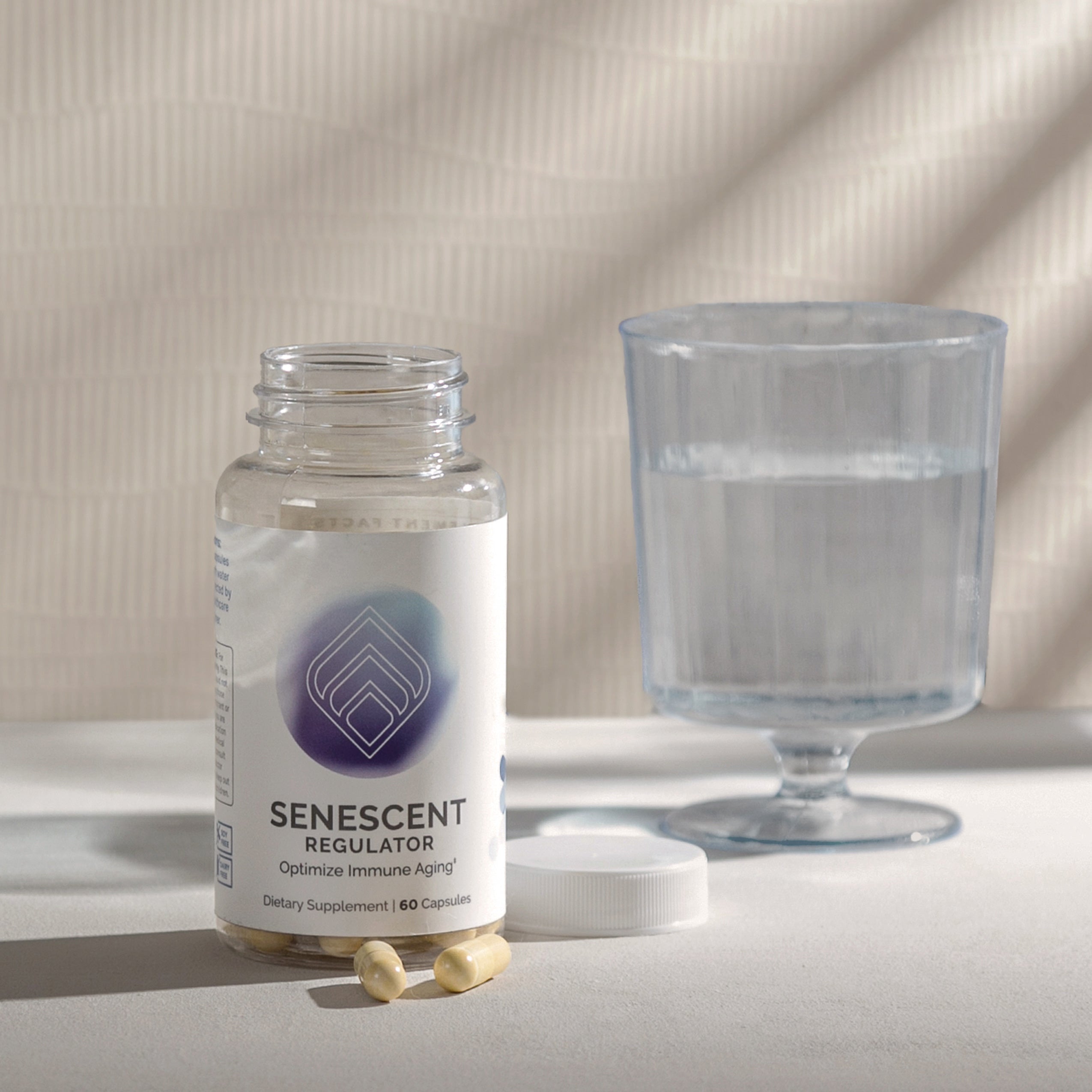 Dietary supplement bottle with capsules, and a glass of water, suggesting usage instructions.