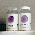 Infiniwell DHH-B Mood Support and DHH-B MAX Mood Support supplement bottles with 30 capsules on light surface