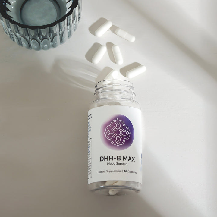 Mood support supplement bottle with capsules, on a light background.
