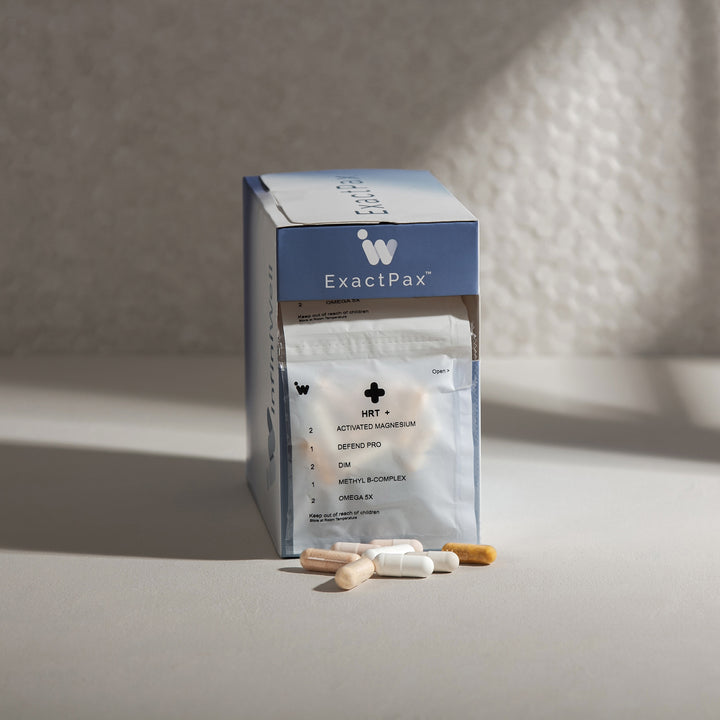 Supplement capsules and packaging on a neutral background.
