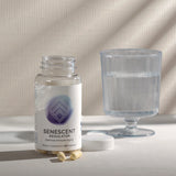 Dietary supplement bottle with capsules, and a glass of water, suggesting usage instructions.
